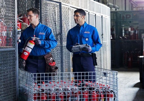 Cintas employees filling a fire extinguisher order