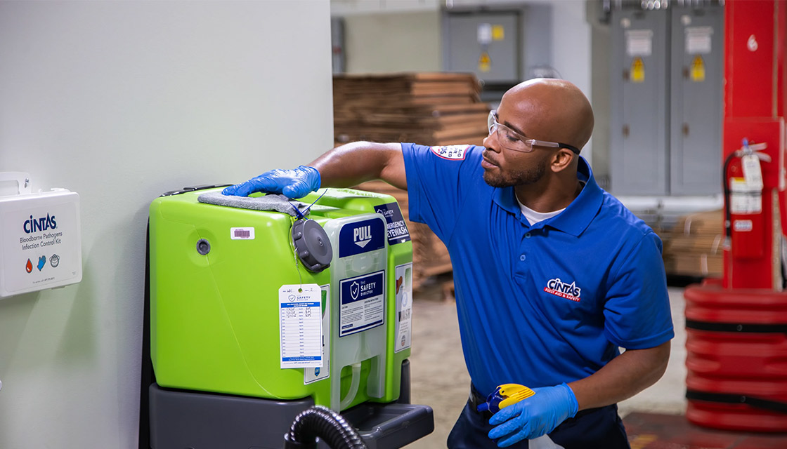 Worker cleaning eyewash