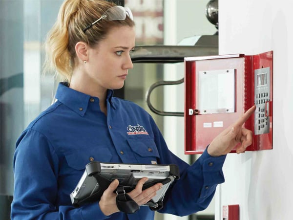 CintasFireProtectionRepresentativeinspectingfirealarmpanel