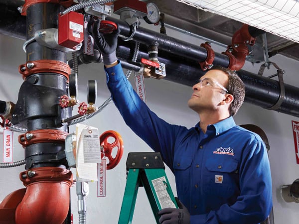 CintasFireProtectionRepresentativeinspectingsprinklersystem