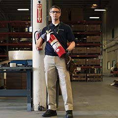 fire technician holding fire extinguisher