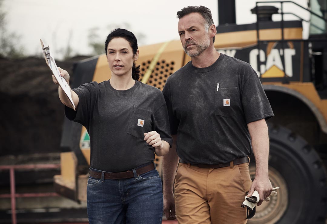 man and woman wearing carhartt workwear
