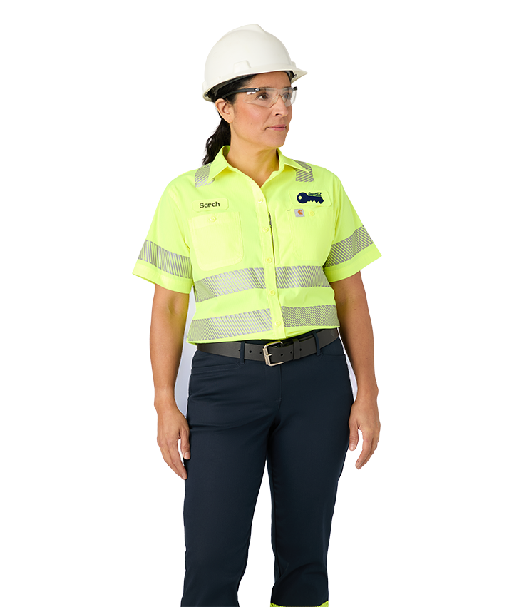 Woman in hard hat wearing visibility apparel | Cintas
